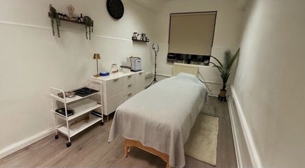 A serene treatment room at Glow Method Crawley, featuring a massage table and soft lighting in Crawley, England, GB.
