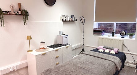 Cozy treatment room at Glow Method Crawley, Crawley, England, GB, featuring a massage table and calming decor.