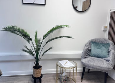 Relaxing waiting area at Glow Method Crawley, Crawley, England, GB with a plush chair and a potted plant.