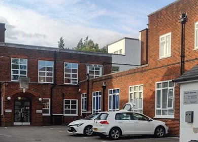 Exterior of Glow Method Crawley, a brick building in Crawley, England, GB with parked cars.