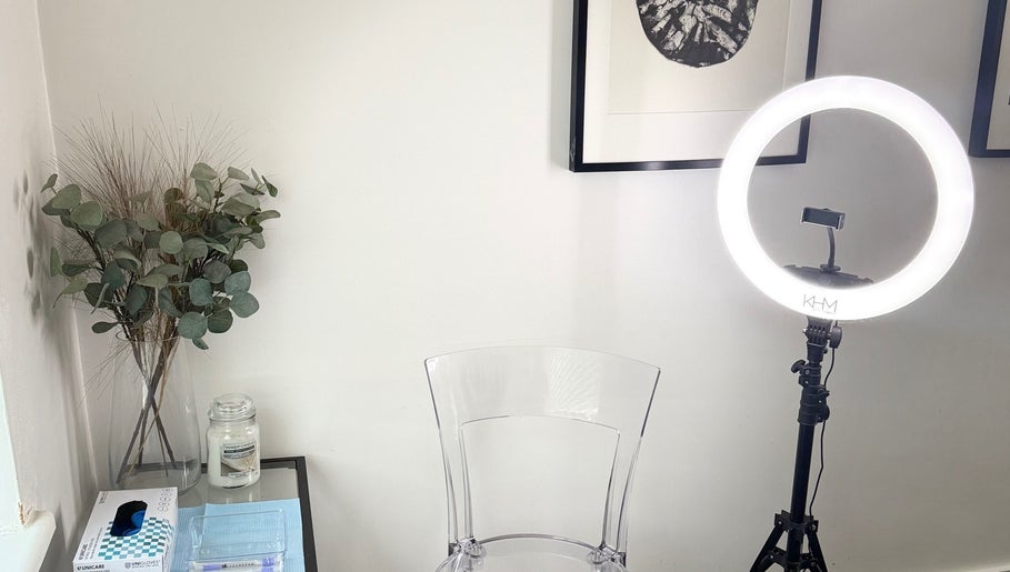 Elegant beauty setup at Refine, Oakdale, Wales, GB with a ring light, chair, and decor.