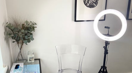 Elegant beauty setup at Refine, Oakdale, Wales, GB with a ring light, chair, and decor.
