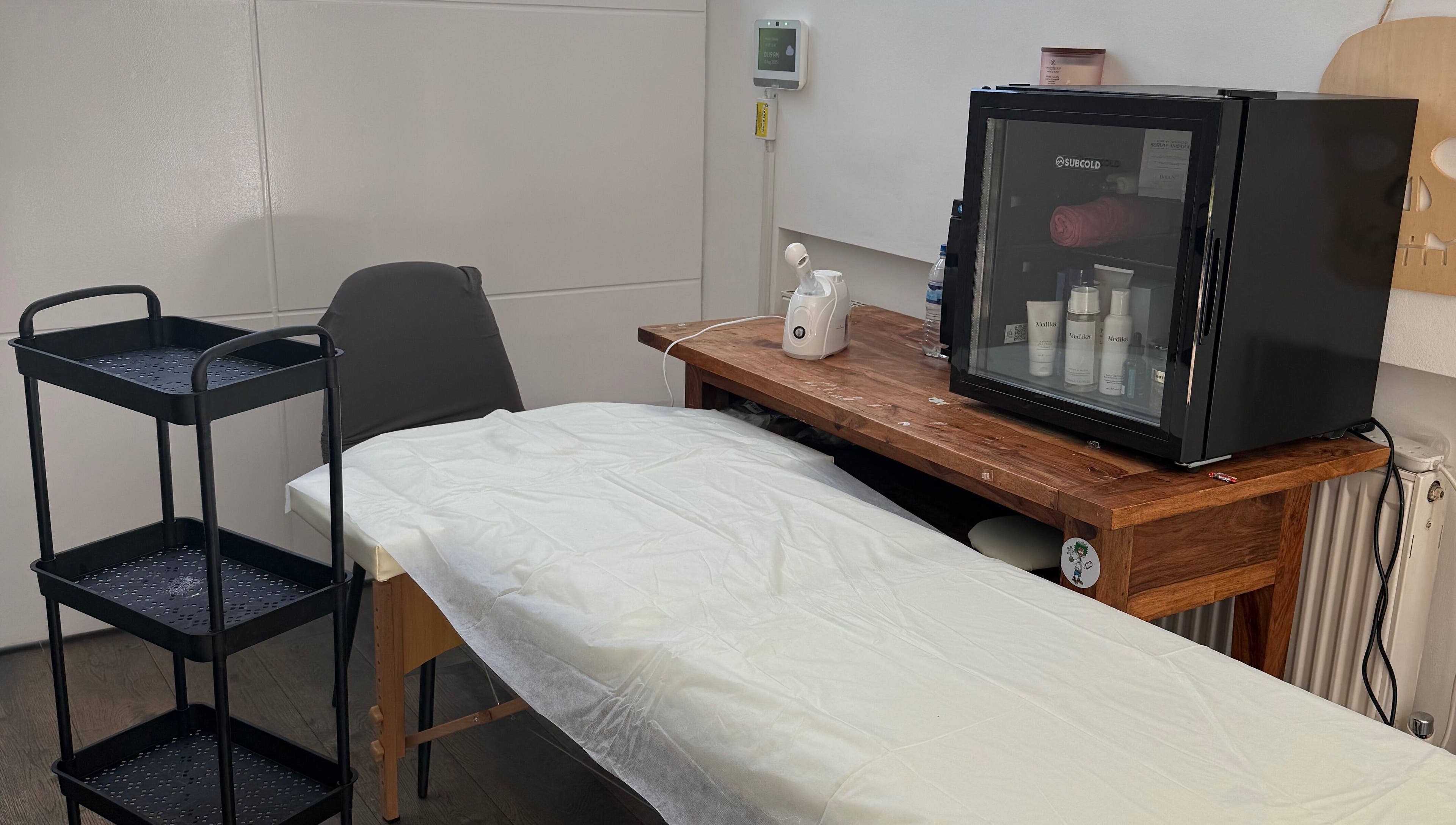 Tranquil spa room at Lilly’s Beauty LDN, London, England, GB featuring a massage table and skincare essentials.