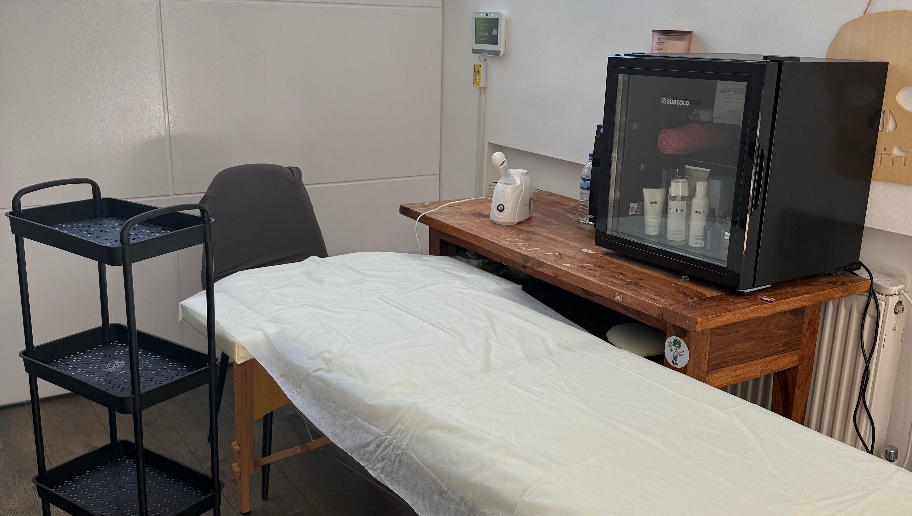 Tranquil spa room at Lilly’s Beauty LDN, London, England, GB featuring a massage table and skincare essentials.