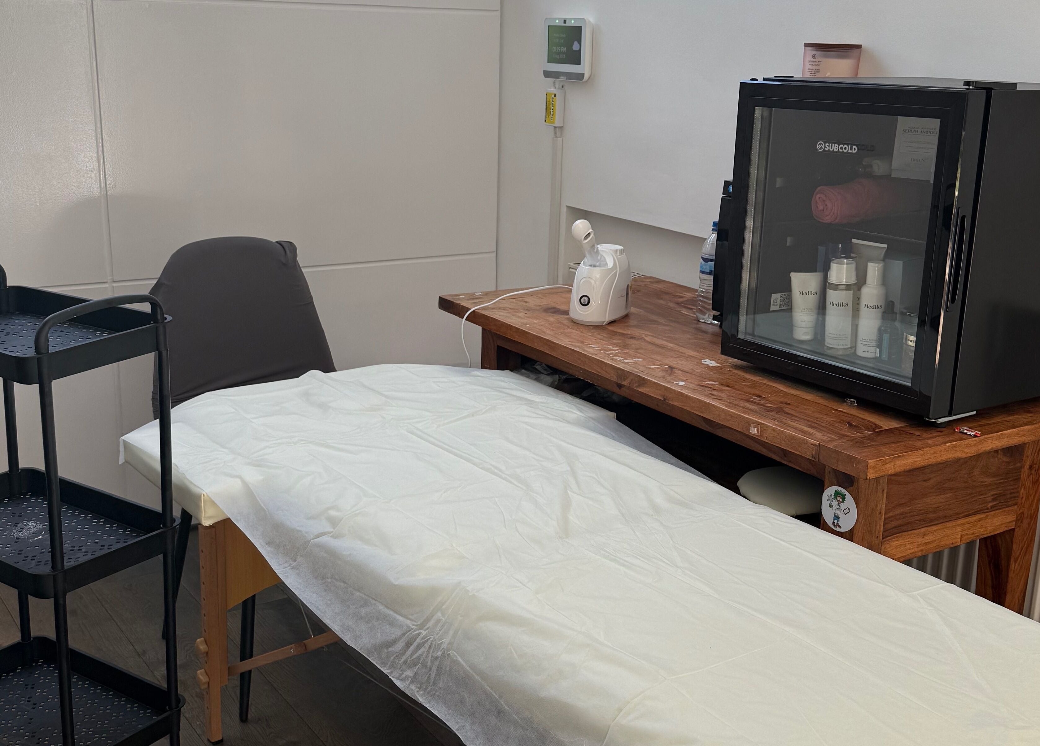 Tranquil spa room at Lilly’s Beauty LDN, London, England, GB featuring a massage table and skincare essentials.