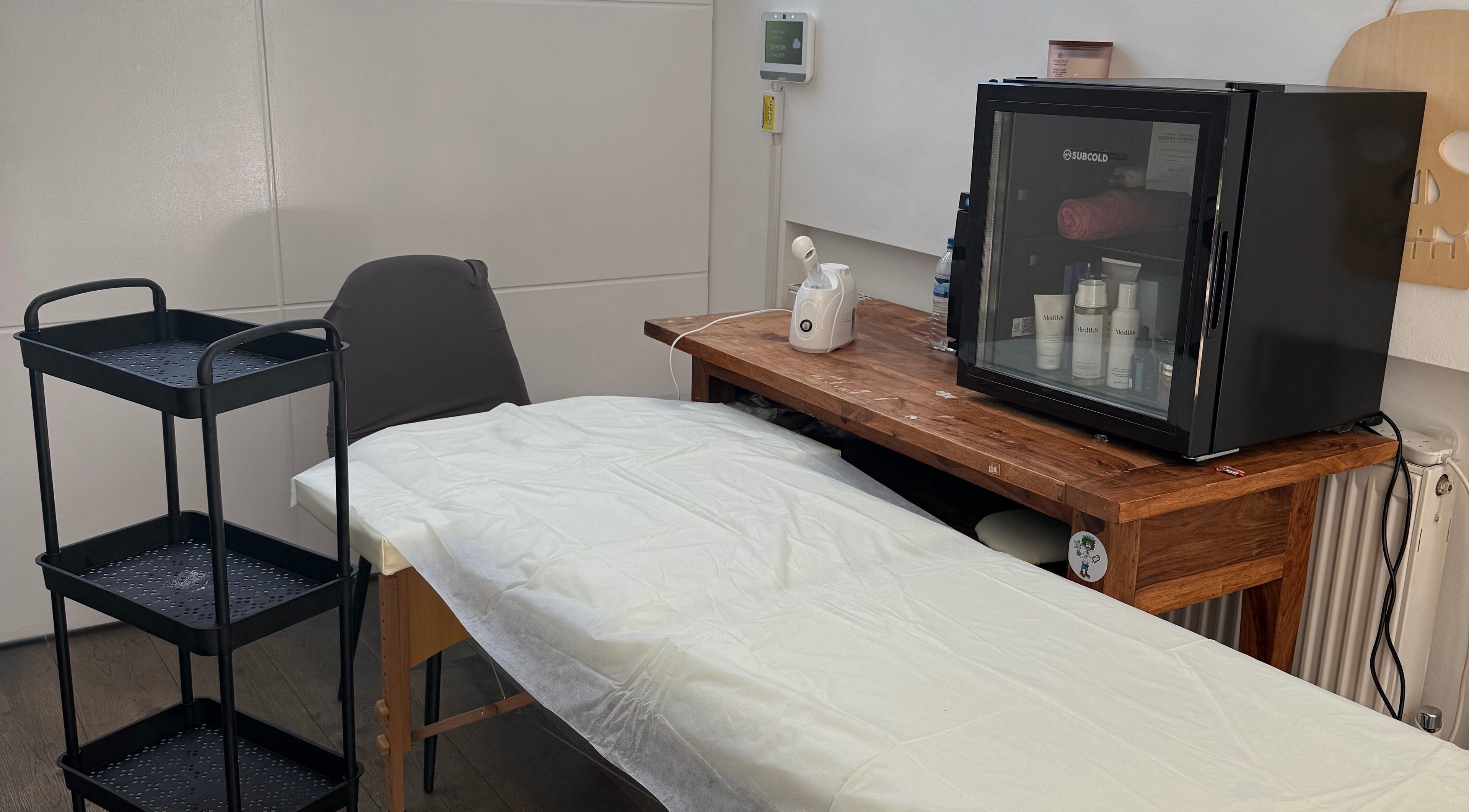 Tranquil spa room at Lilly’s Beauty LDN, London, England, GB featuring a massage table and skincare essentials.