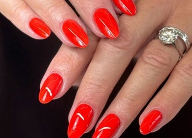Vibrant red manicure at Laque Nail Bar, Vancouver, British Columbia, CA. Elegant nails polished to perfection.