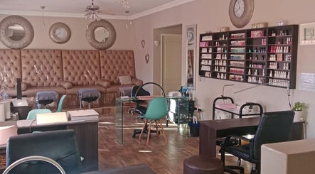 Chic salon setting at -M- Beauty, Alberton, Gauteng, ZA, featuring plush seating and nail polish display.
