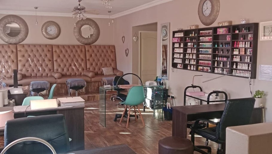 Luxurious lounge at M Beauty, Alberton, Gauteng, ZA with stylish decor and nail polish display.