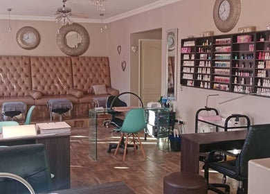Luxurious lounge at M Beauty, Alberton, Gauteng, ZA with stylish decor and nail polish display.