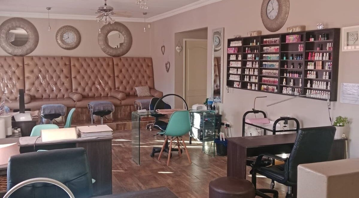 Luxurious lounge at M Beauty, Alberton, Gauteng, ZA with stylish decor and nail polish display.