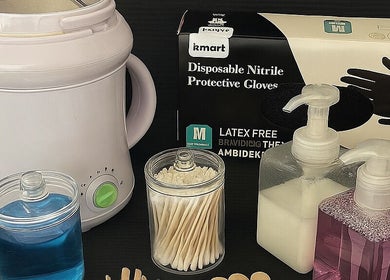 Beauty essentials used at Bareandbronzedbykatex, Saltney, Wales, GB, including wax warmer, gloves, and lotions.