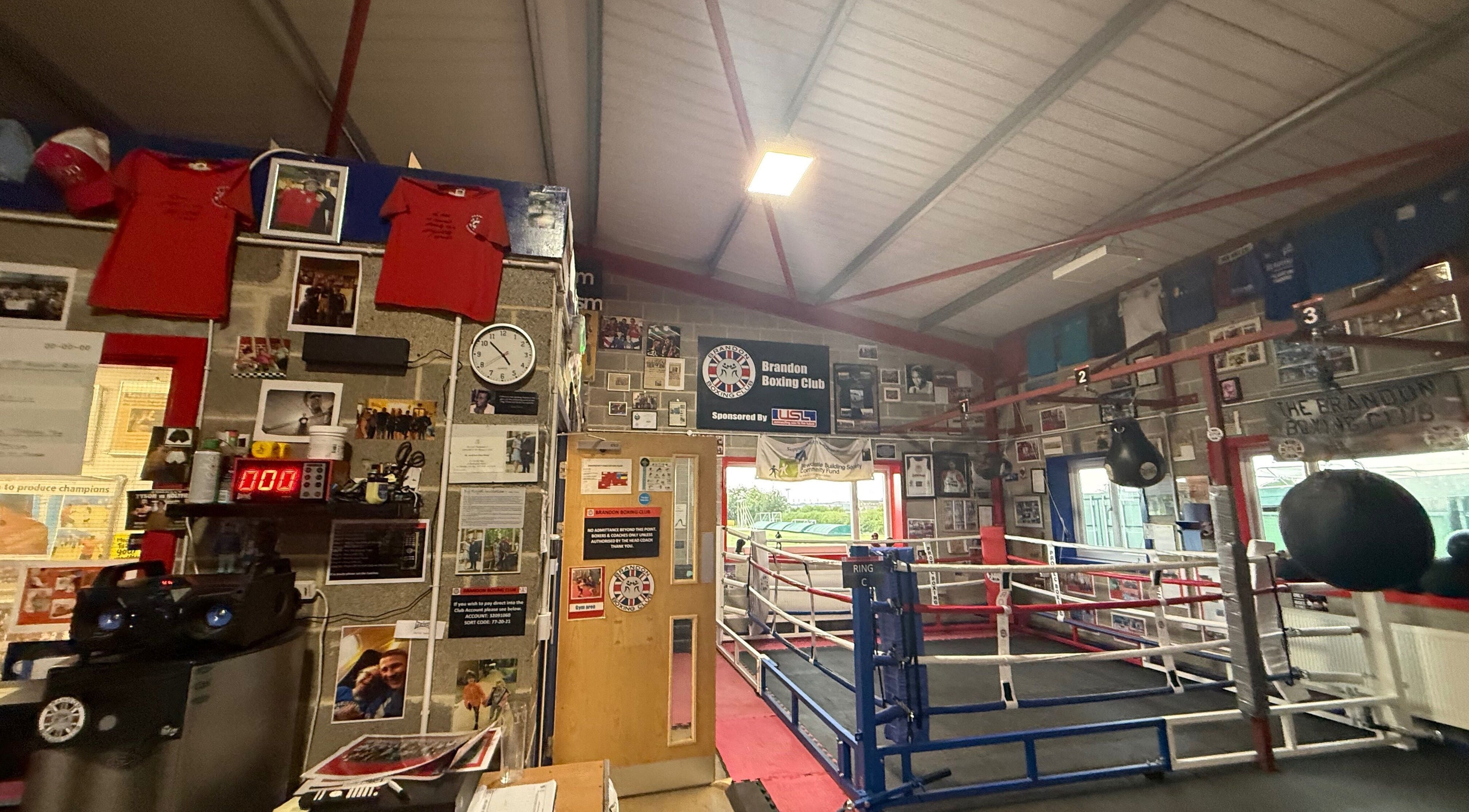 Interior of Train With TNT, Brandon, England, GB, showcasing boxing ring and memorabilia-filled walls