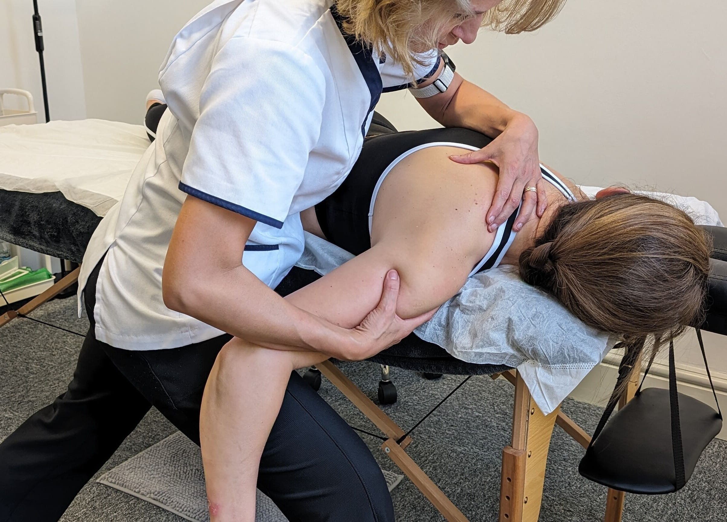 Therapist at RENEWAL INTEGRATIVE REHAB in Southampton, England, GB performing shoulder therapy.