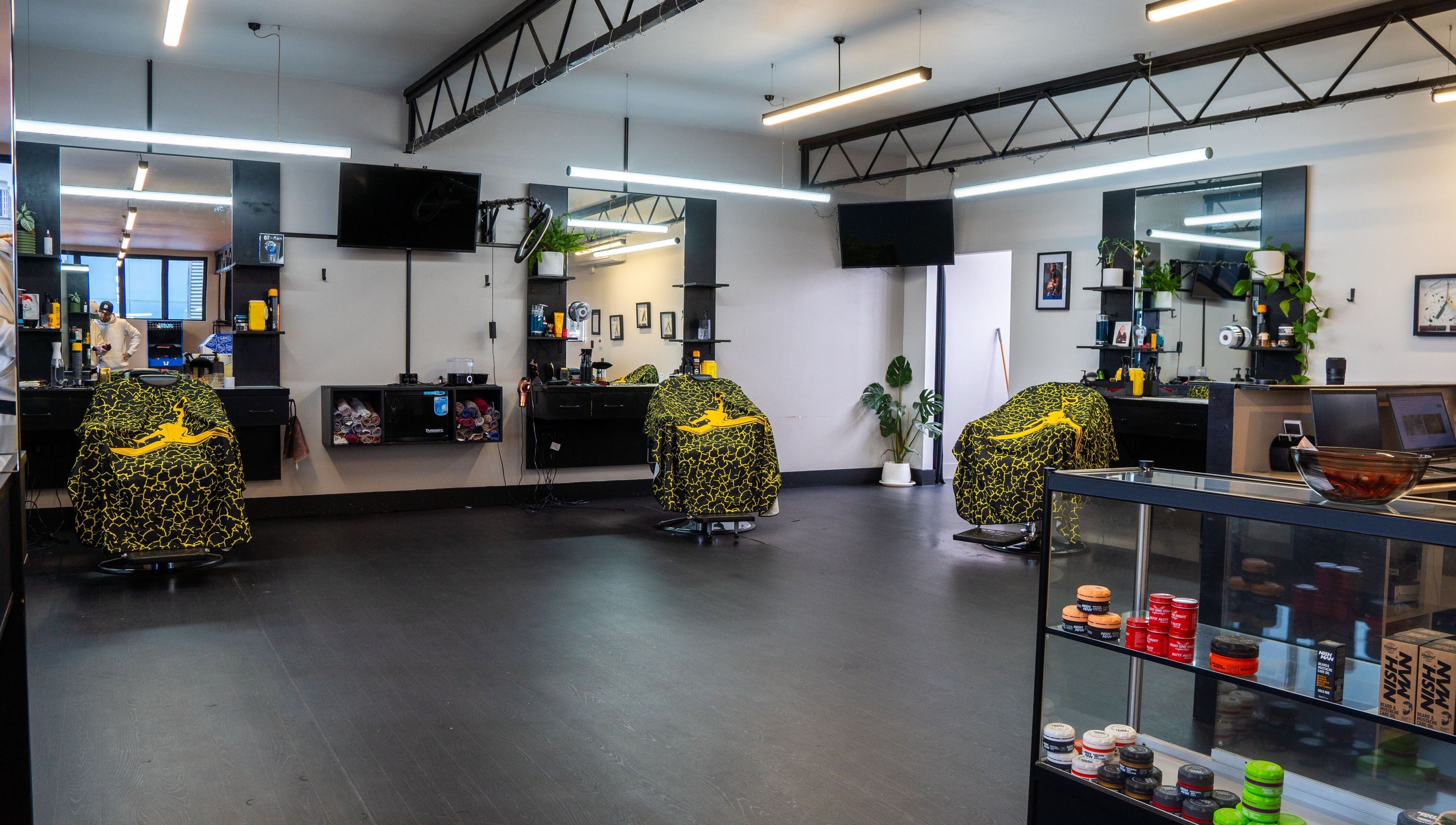 Modern interior of Eight One Eight Barbershop in Auckland, Auckland, NZ featuring stylish barber chairs.