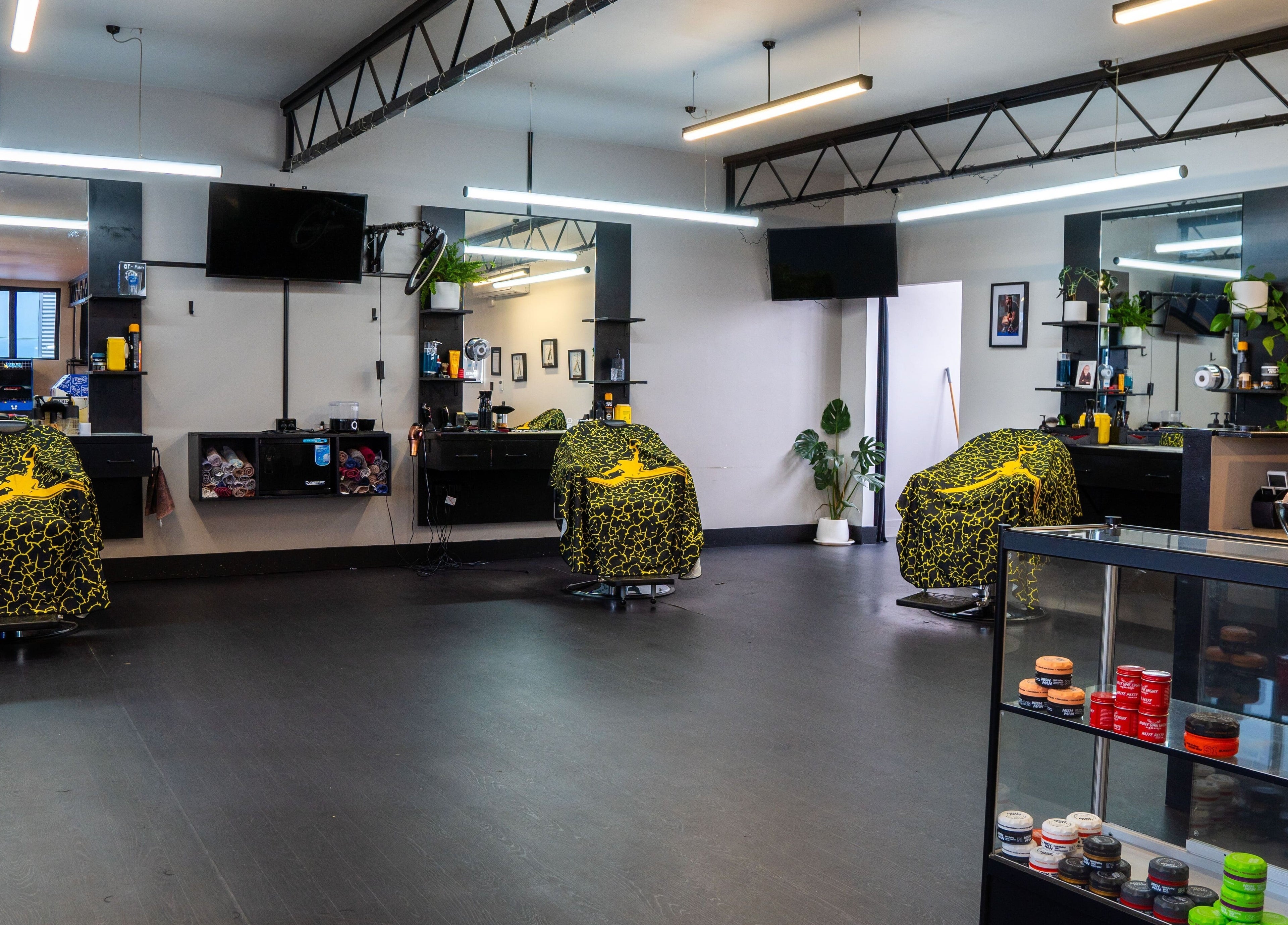 Modern interior of Eight One Eight Barbershop in Auckland, Auckland, NZ featuring stylish barber chairs.