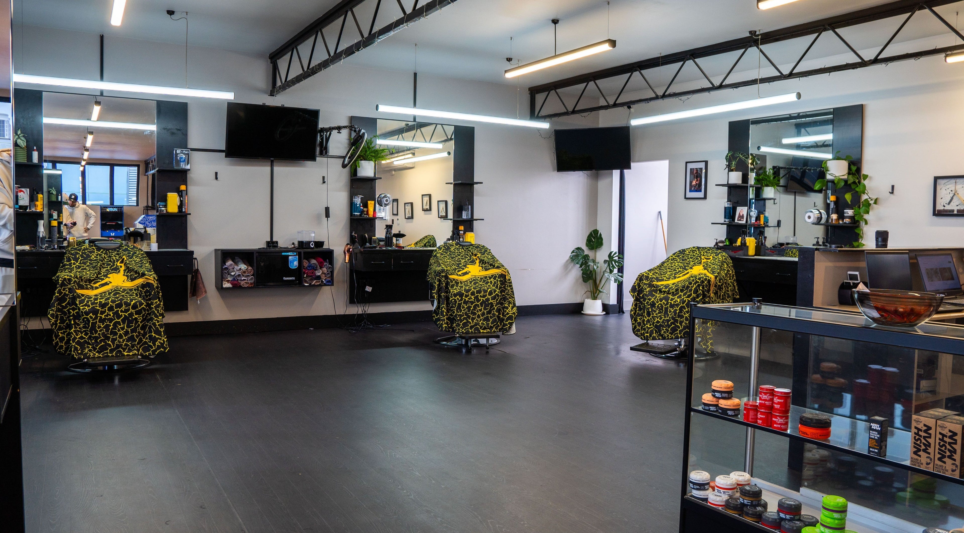 Modern interior of Eight One Eight Barbershop in Auckland, Auckland, NZ featuring stylish barber chairs.