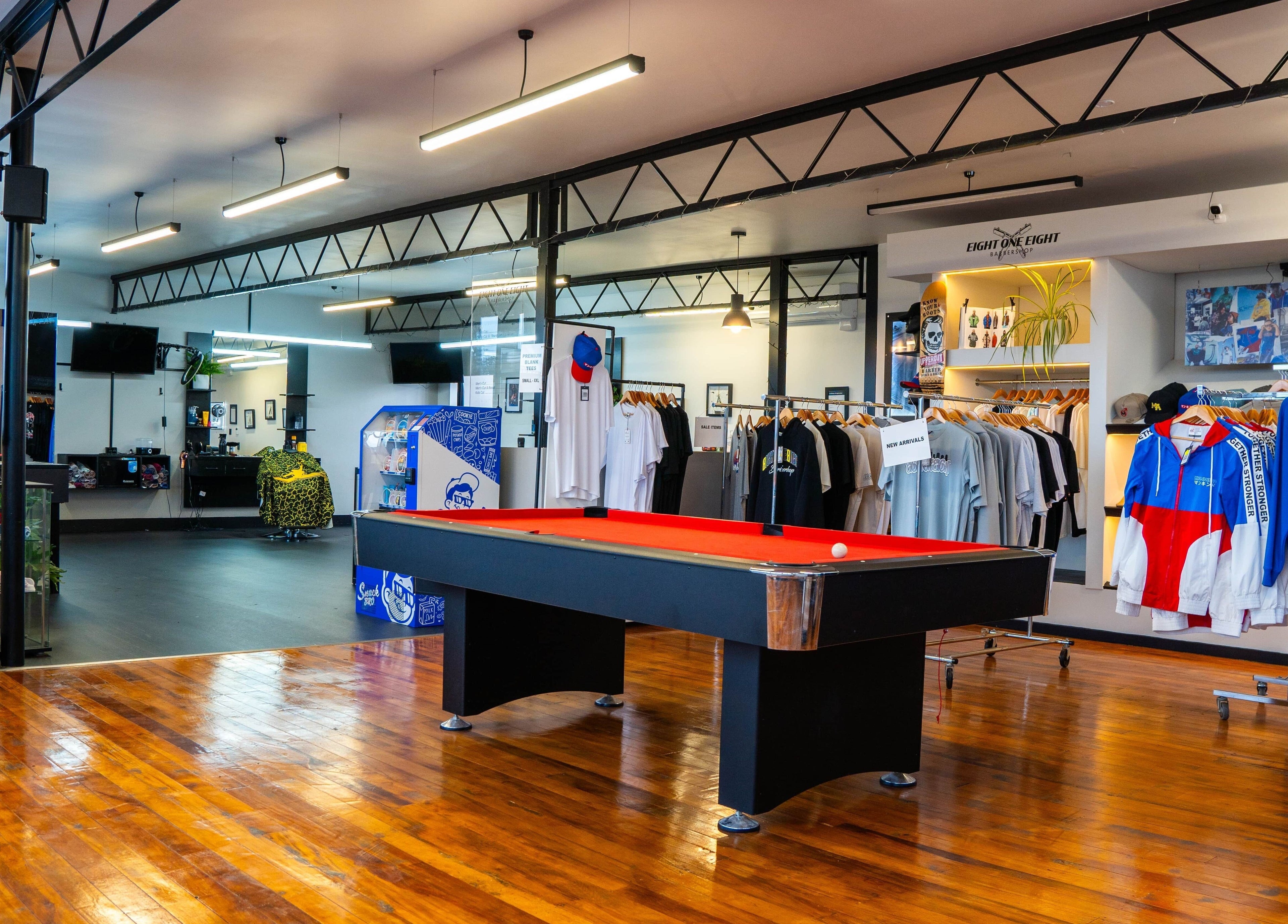 Spacious interior of Eight One Eight Barbershop in Auckland, Auckland, NZ featuring modern design and pool table.