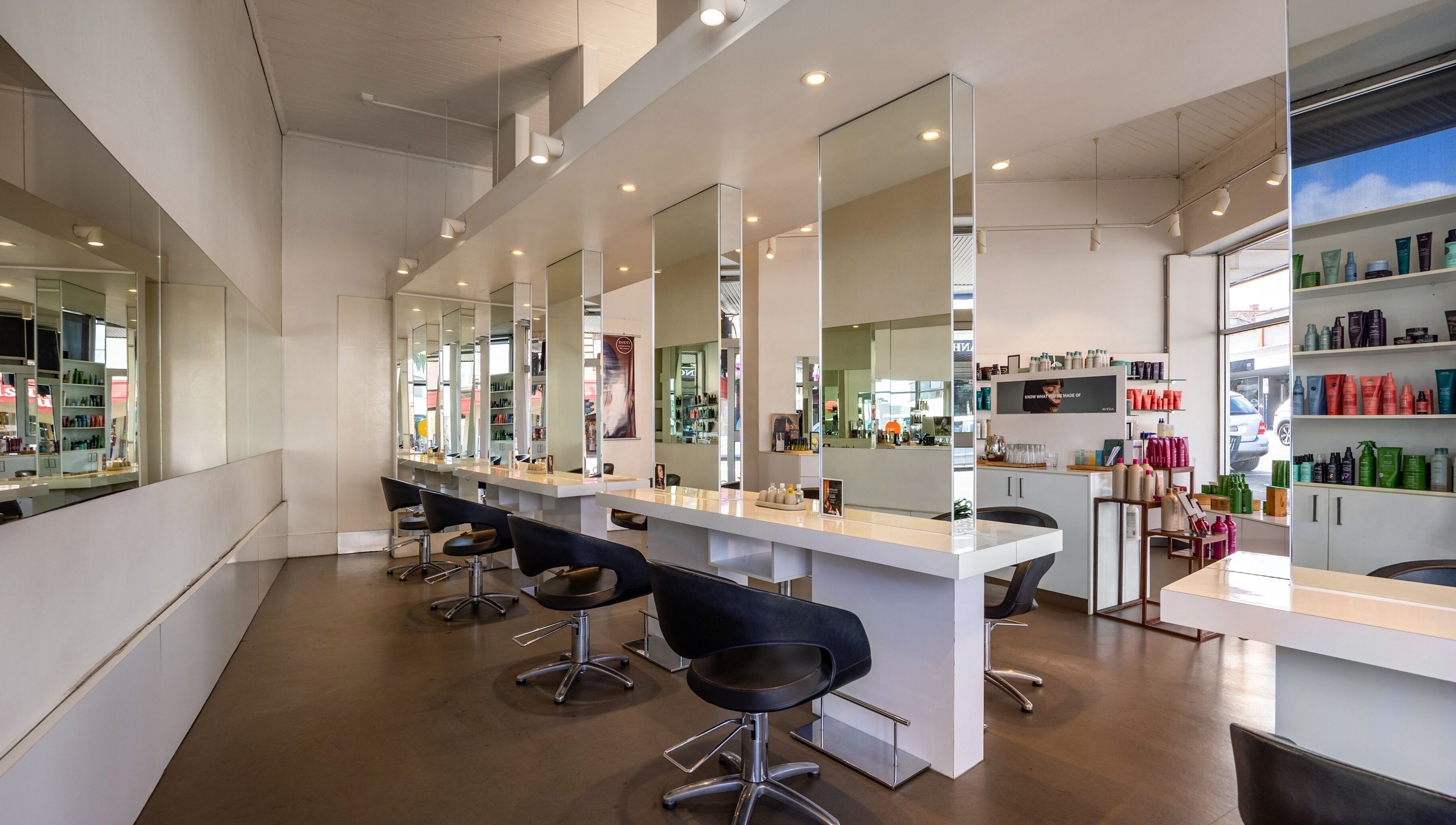 Modern interior of Zucci Ivanhoe salon in Melbourne, Victoria, AU featuring elegant styling stations.