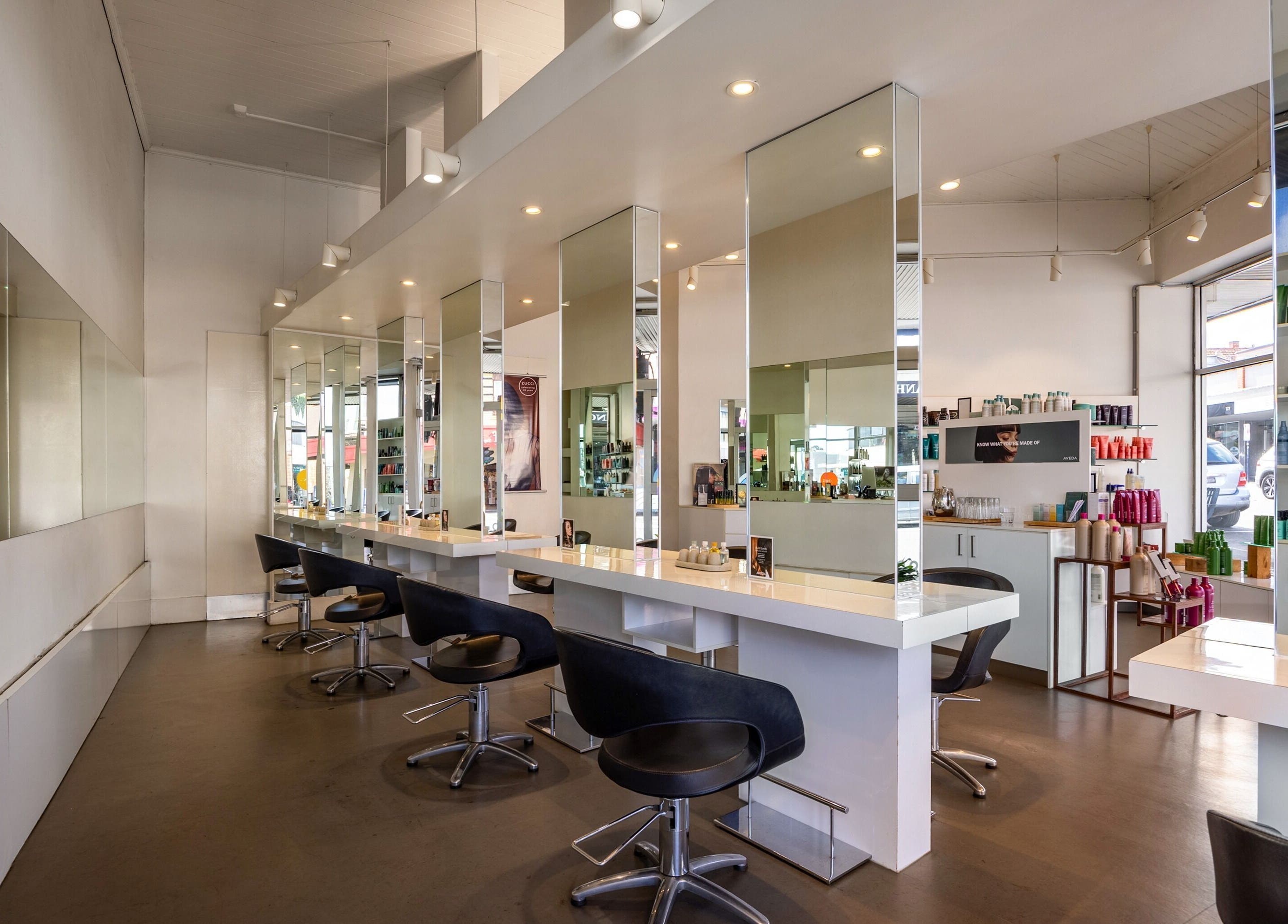 Modern interior of Zucci Ivanhoe salon in Melbourne, Victoria, AU featuring elegant styling stations.