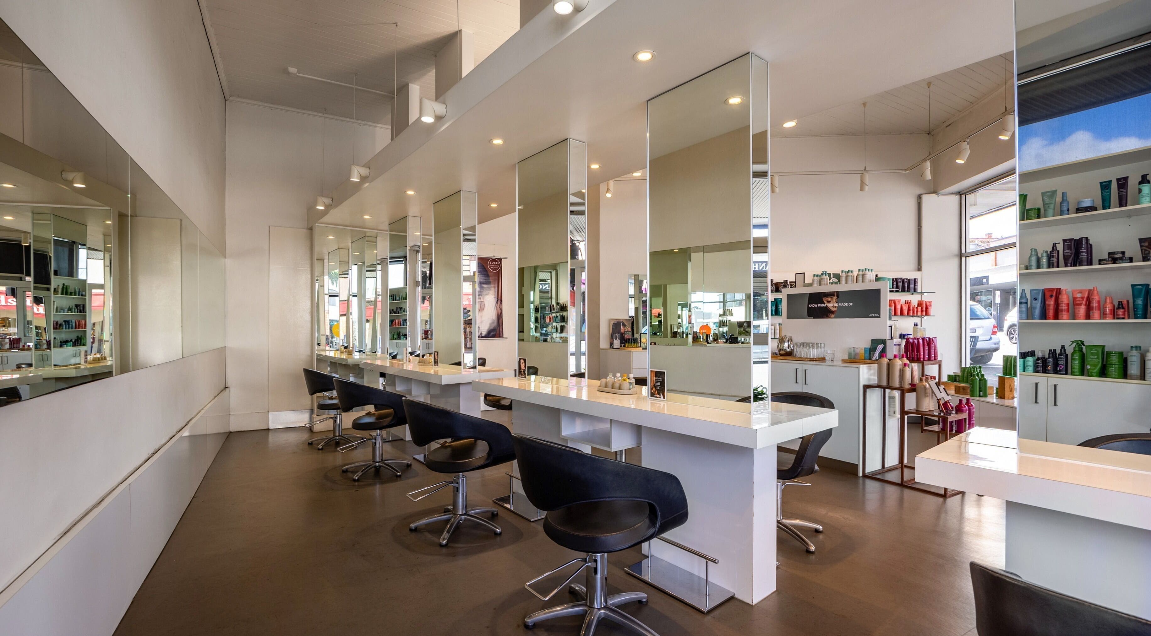 Modern interior of Zucci Ivanhoe salon in Melbourne, Victoria, AU featuring elegant styling stations.