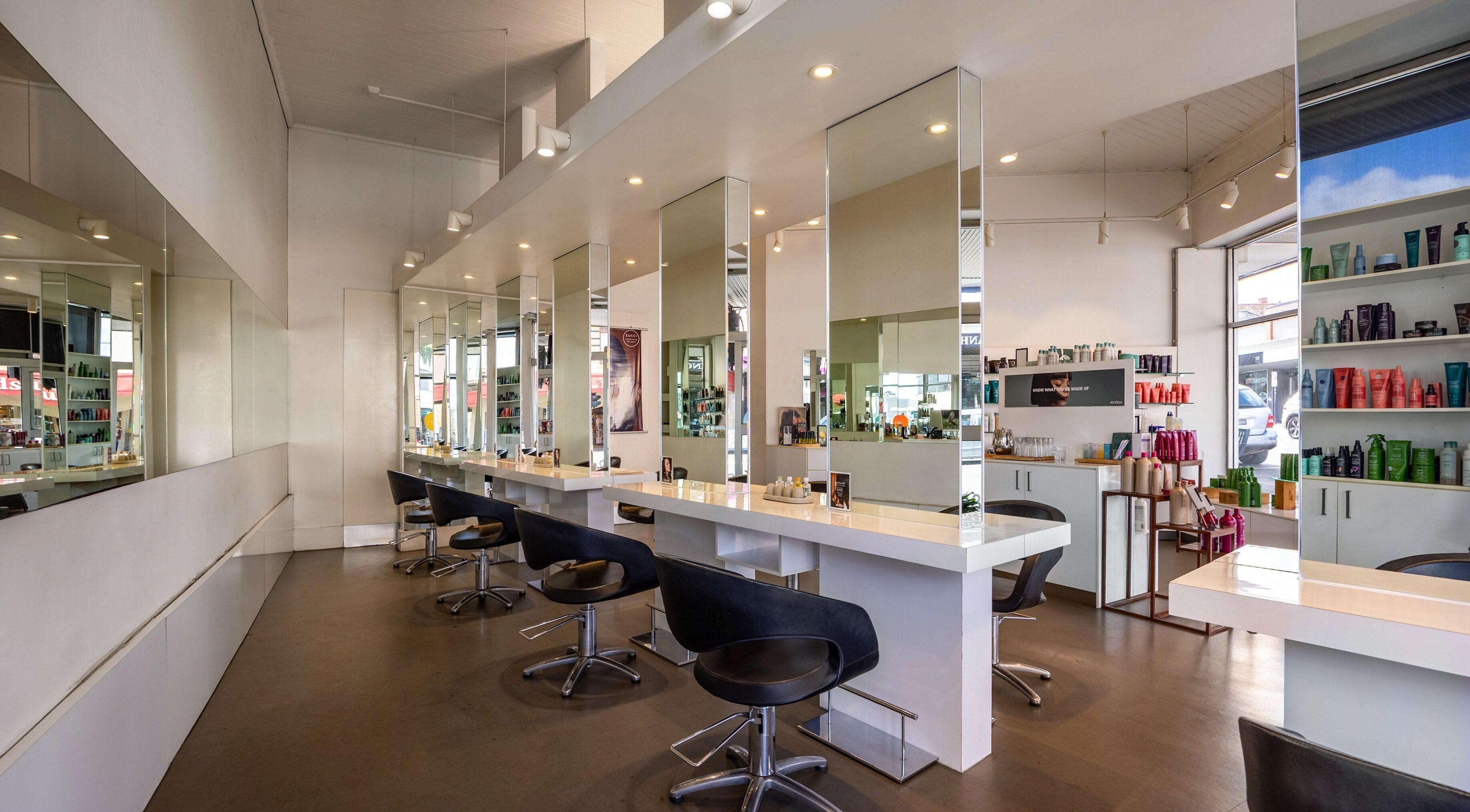 Modern interior of Zucci Ivanhoe salon in Melbourne, Victoria, AU featuring elegant styling stations.