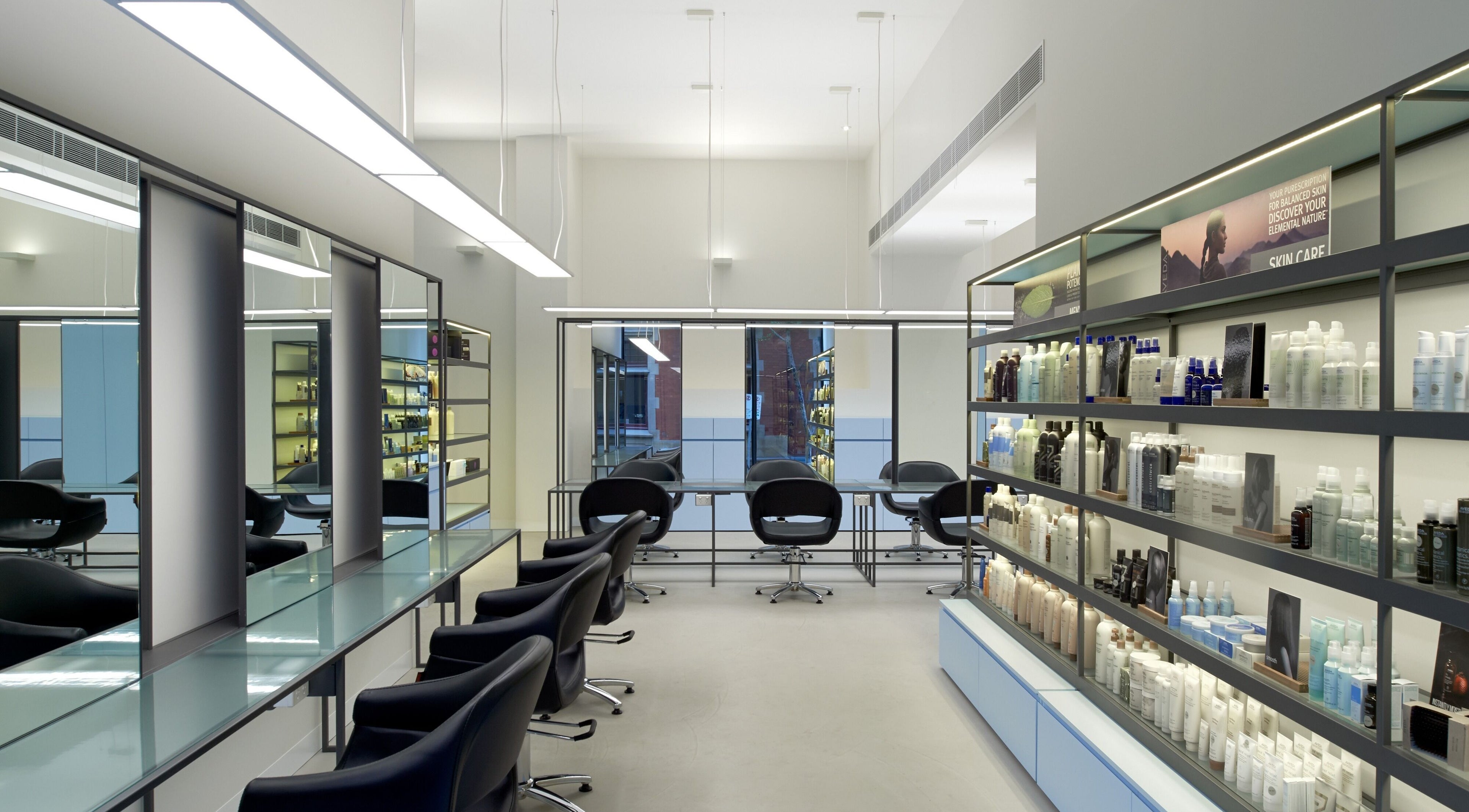 Modern interior of Zucci Bourke St CBD in Melbourne, Victoria, AU with sleek styling stations and product shelves.