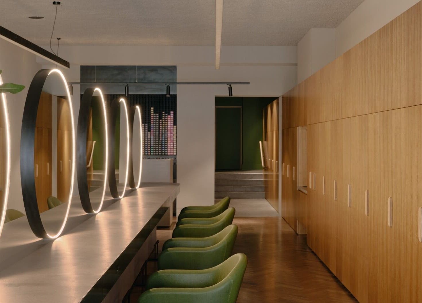 Modern interior with green chairs and glowing mirrors at Zucci South Melbourne, Melbourne, Victoria, AU.