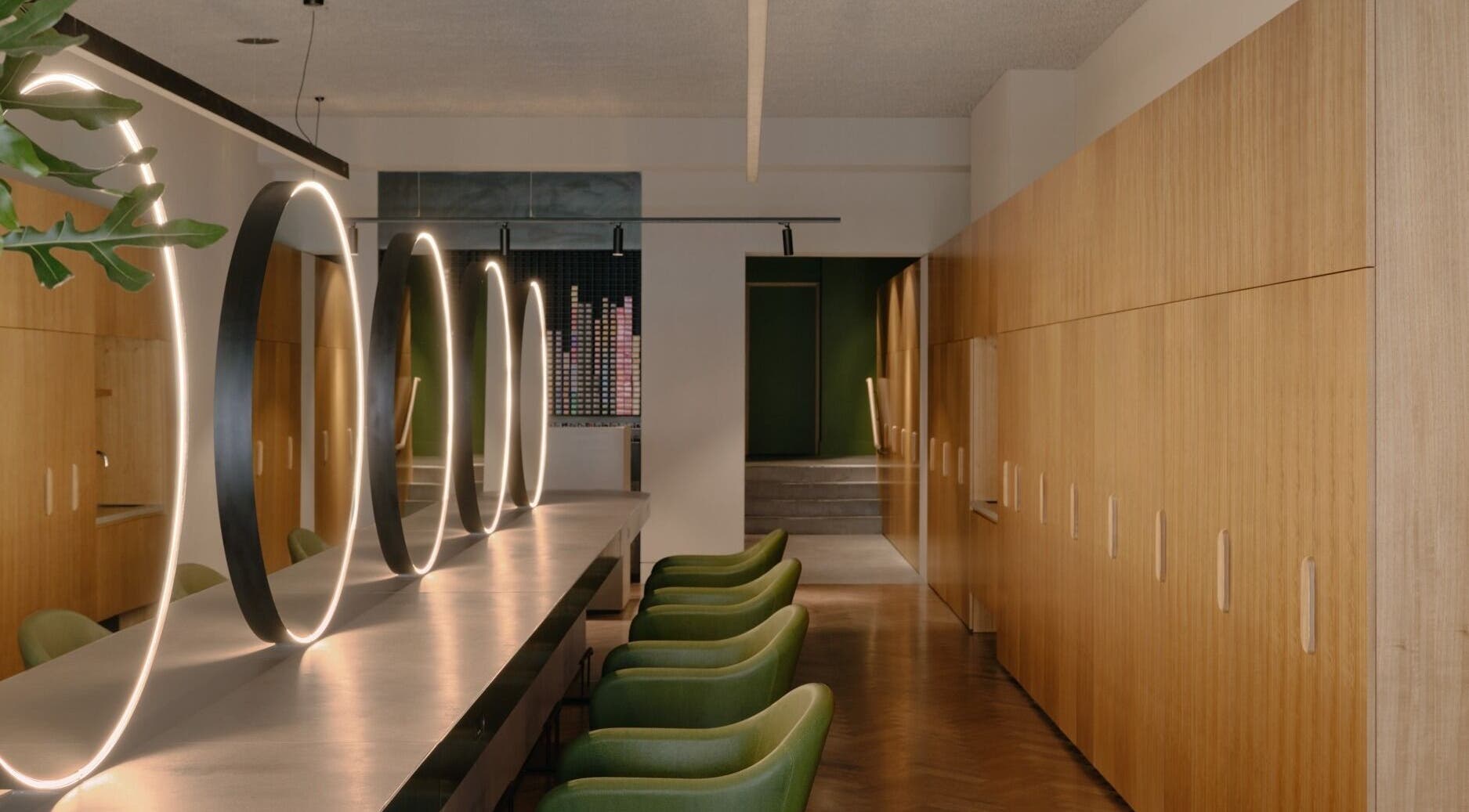 Modern interior with green chairs and glowing mirrors at Zucci South Melbourne, Melbourne, Victoria, AU.