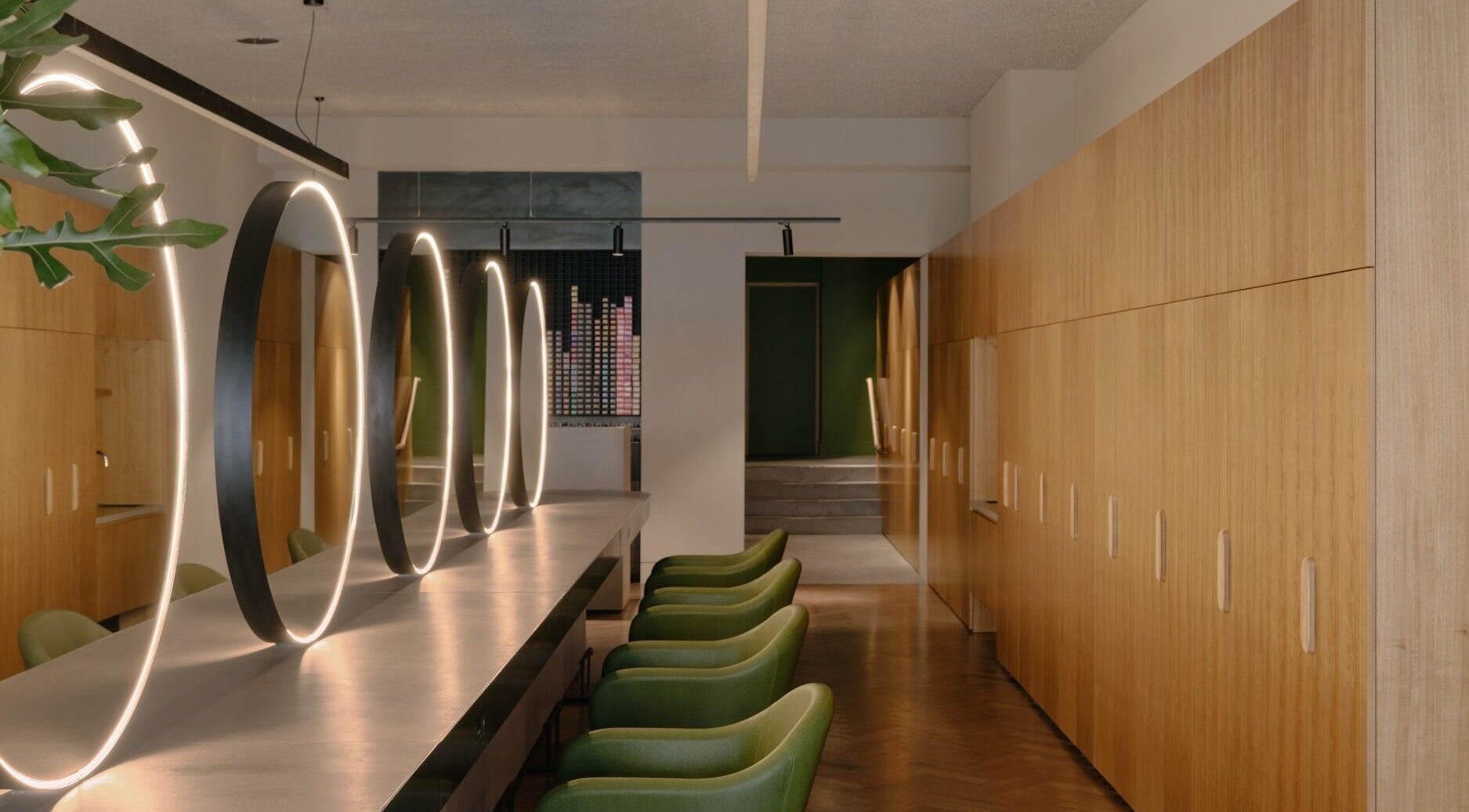 Modern interior with green chairs and glowing mirrors at Zucci South Melbourne, Melbourne, Victoria, AU.