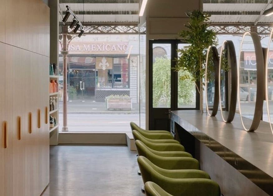 Chic interior of Zucci South Melbourne with green chairs and mirrors in Melbourne, Victoria, AU.