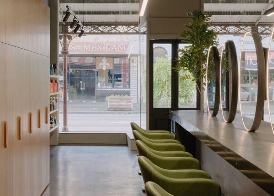 Chic interior of Zucci South Melbourne with green chairs and mirrors in Melbourne, Victoria, AU.