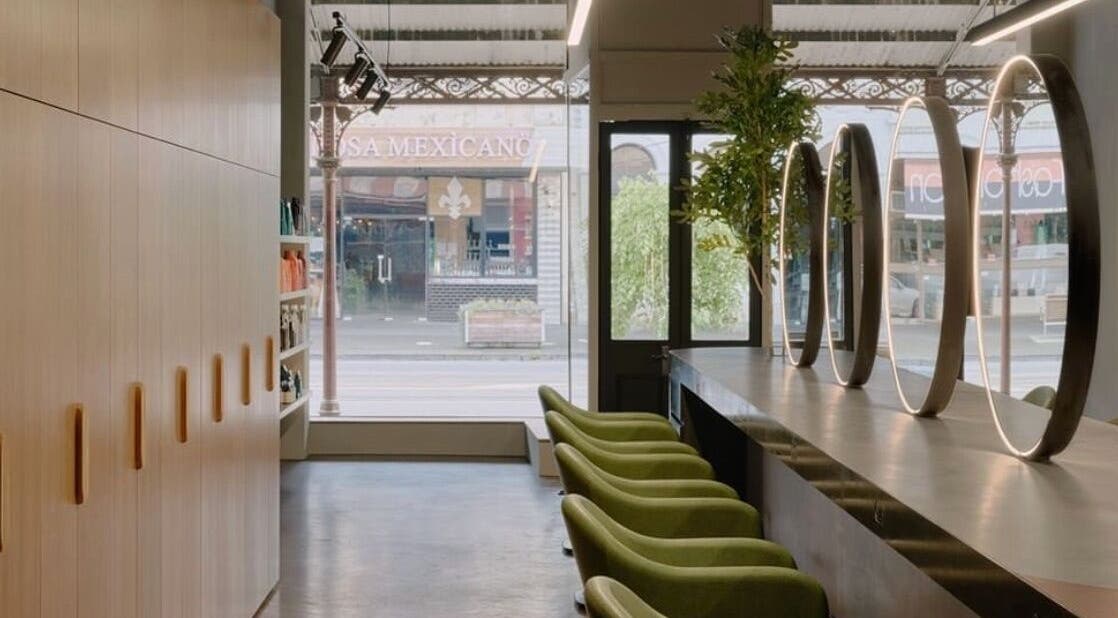 Chic interior of Zucci South Melbourne with green chairs and mirrors in Melbourne, Victoria, AU.