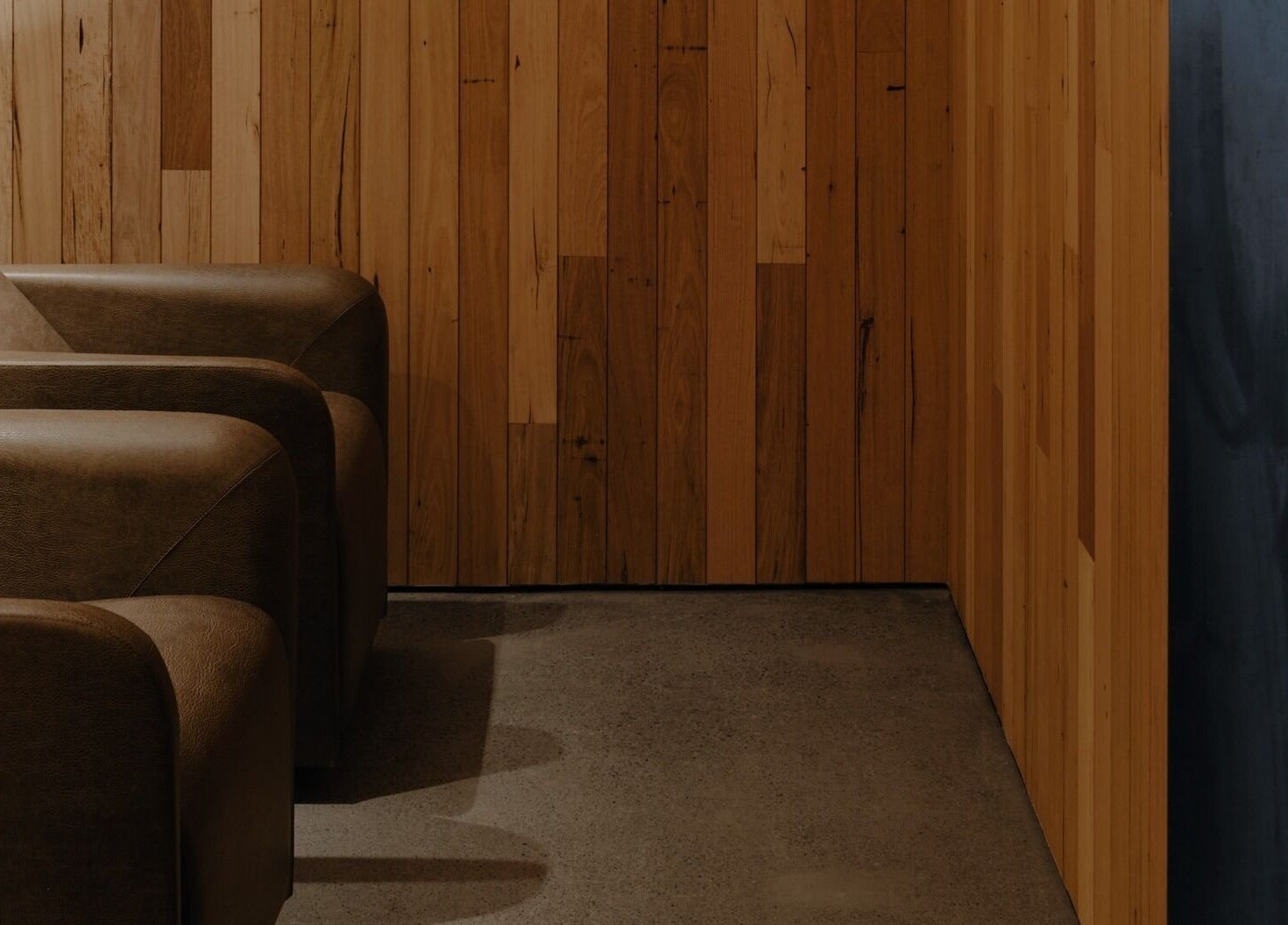 Luxurious lounge chairs at Zucci South Melbourne, Melbourne, Victoria, AU, with elegant wooden wall decor.