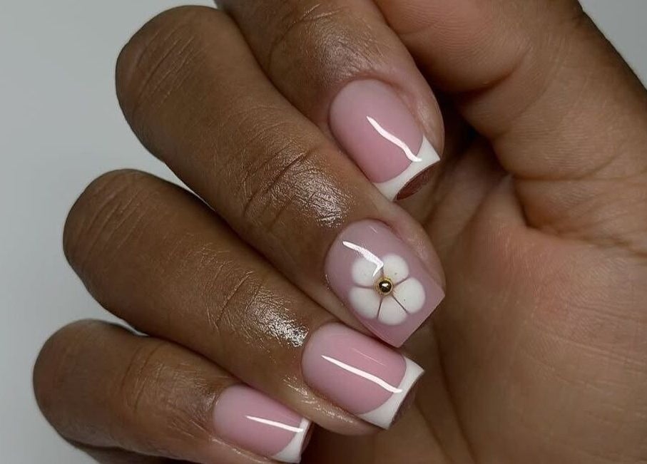 Elegant pink and white nail art with a floral design at Dolled Beauties & Gents, ZA.