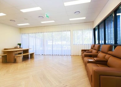 Spacious lounge at Excelsius Wellness in Forest Glen, Queensland featuring plush seating and natural lighting.