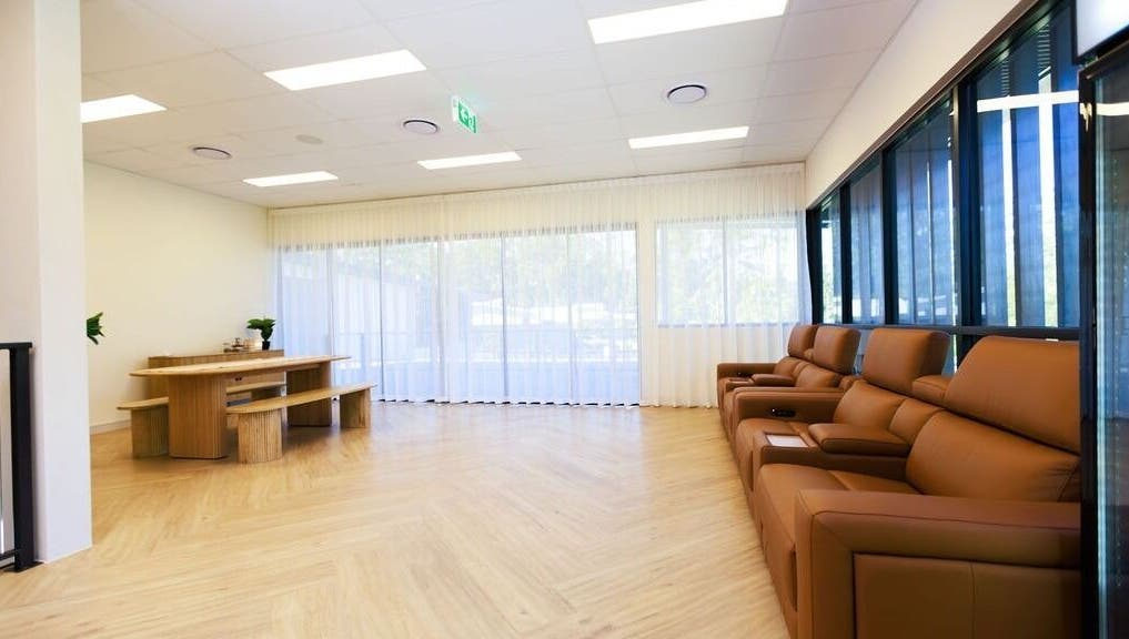 Spacious seating area at Excelsius Wellness Classes, Forest Glen, Queensland, AU, featuring plush leather couches.