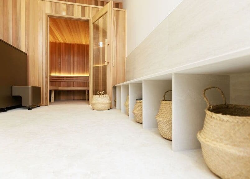 Relaxing sauna at Excelsius Wellness Classes, Forest Glen, Queensland, AU, with woven baskets and wood interior.