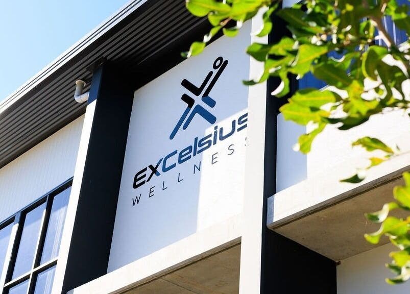 Exterior view of Excelsius Wellness Classes in Forest Glen, Queensland, AU, featuring elegant signage and architecture.