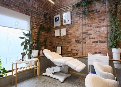Relaxing treatment room at Nurse Amy Aesthetics, Paddington, New South Wales, AU with lush greenery and certificates.
