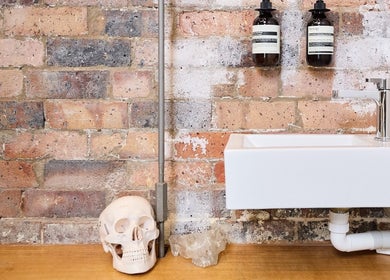 Modern sink with a rustic brick backdrop at Nurse Amy Aesthetics, Paddington, New South Wales, AU.