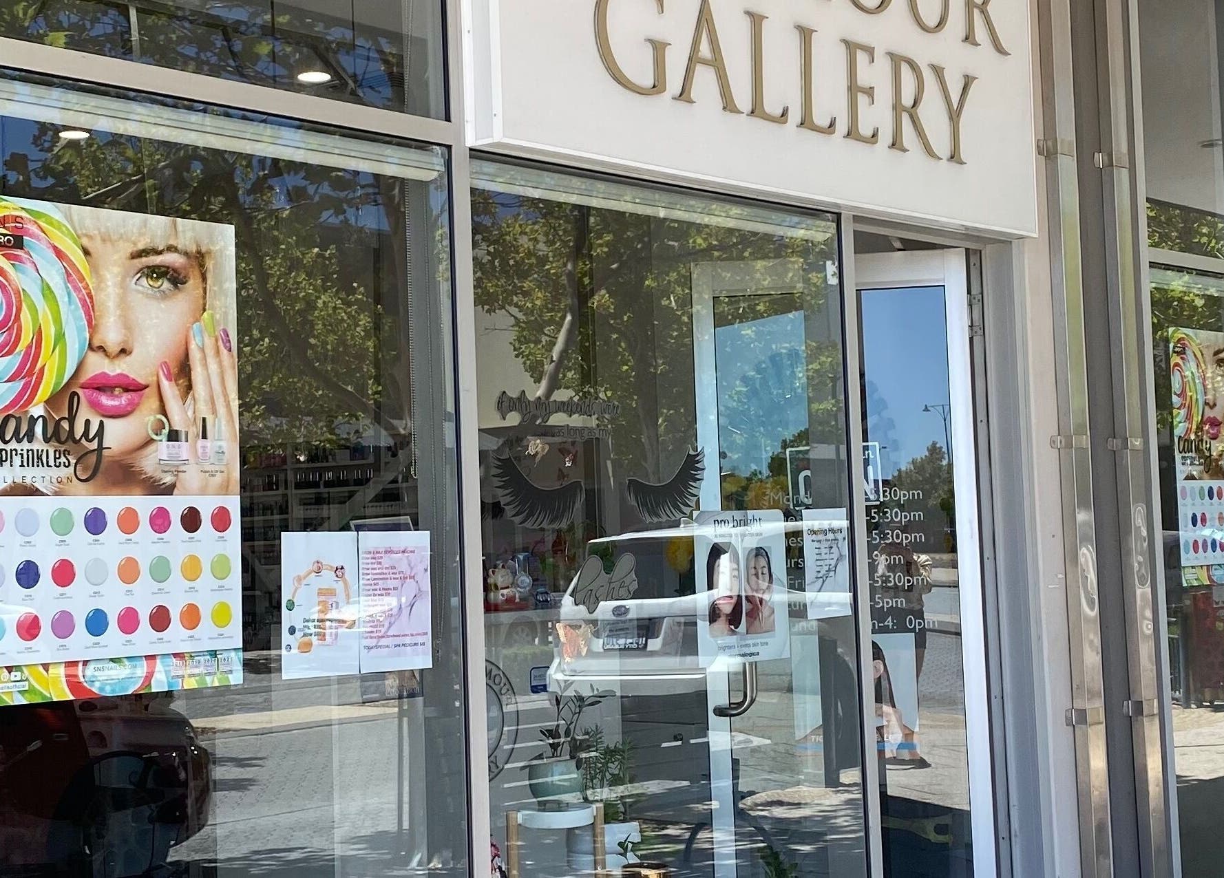 Entrance of The Glamour Gallery in Ellenbrook, Western Australia, AU showcasing colorful promotional posters.