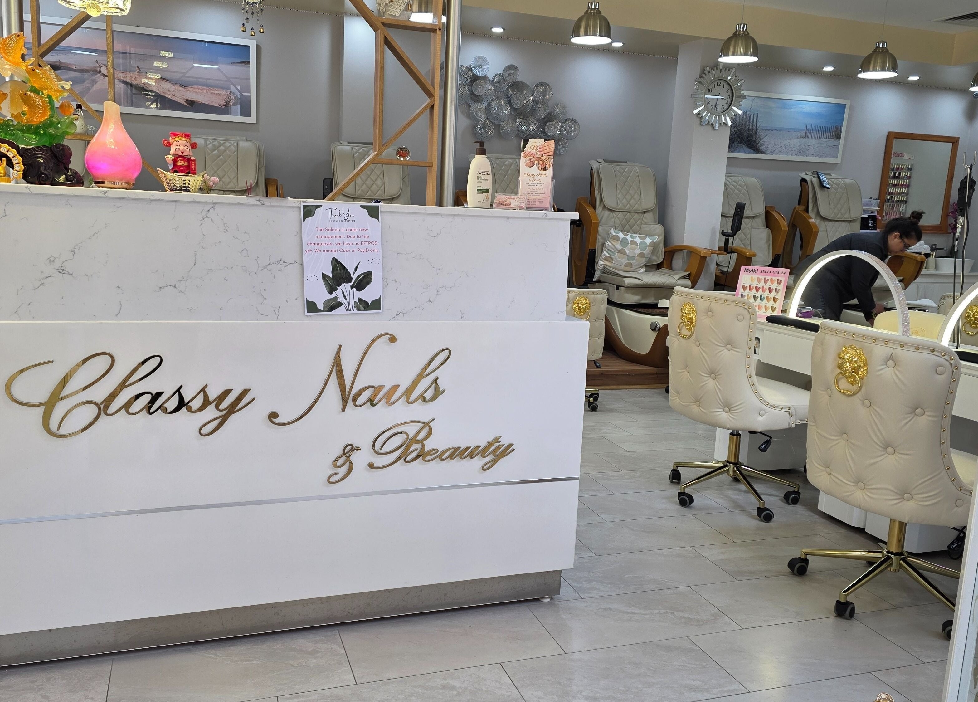 Elegant salon counter at Classy Nail & Beauty, Fremantle, Western Australia, AU with decorative white chairs.