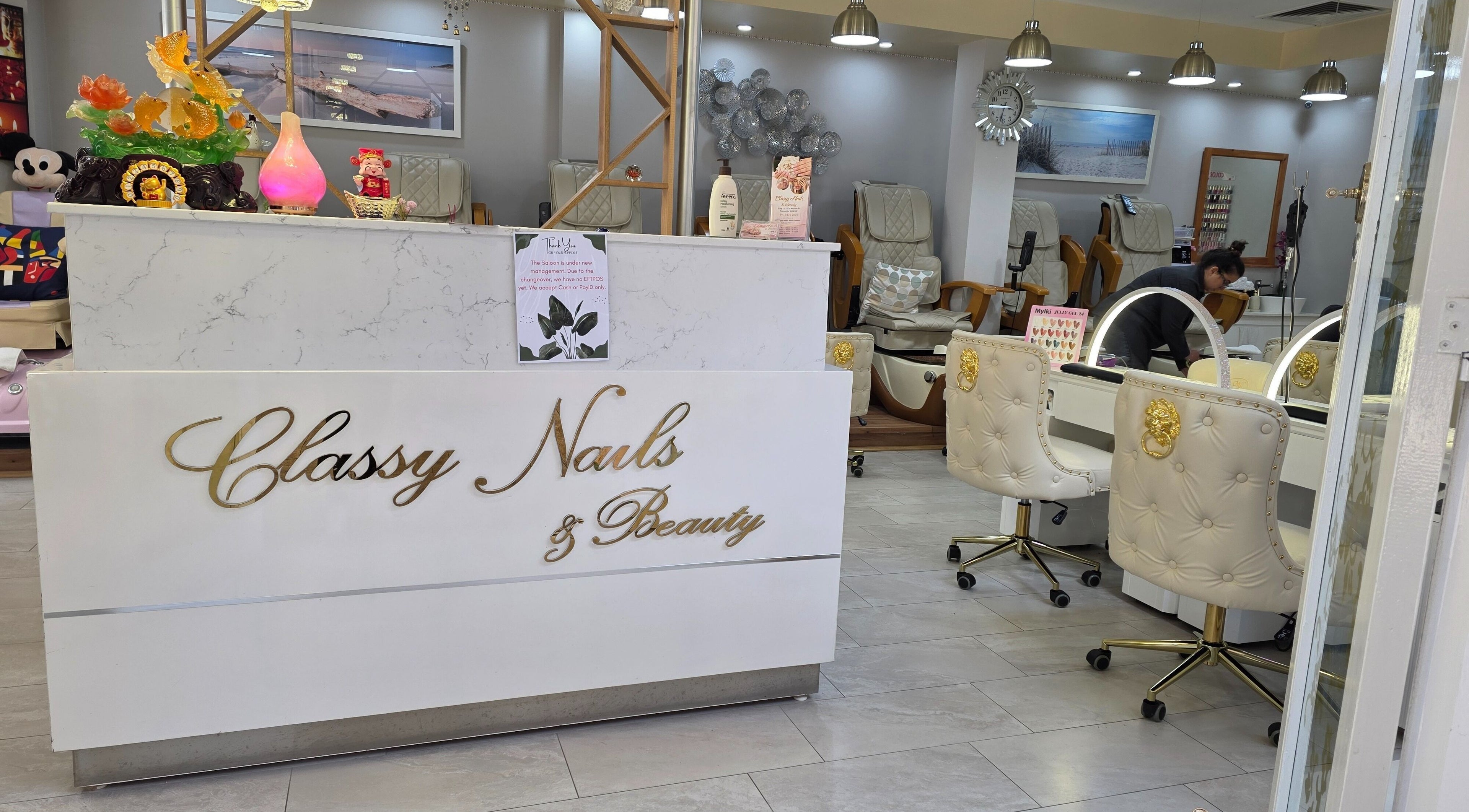 Elegant salon counter at Classy Nail & Beauty, Fremantle, Western Australia, AU with decorative white chairs.