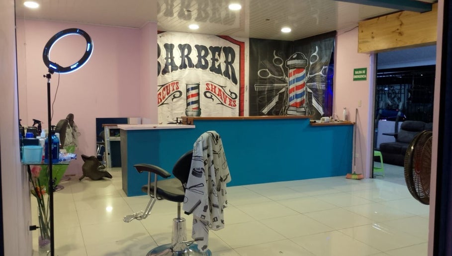 Interior de Flow Barbershop en San Jose Province, Alajuela Province, CR, con ambiente iluminado y silla moderna.