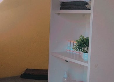Organized shelf with towels and beauty products at Bontlebotse Beauty, Boksburg, Gauteng, ZA.