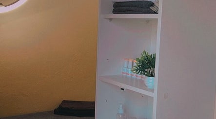 Organized shelf with towels and beauty products at Bontlebotse Beauty, Boksburg, Gauteng, ZA.