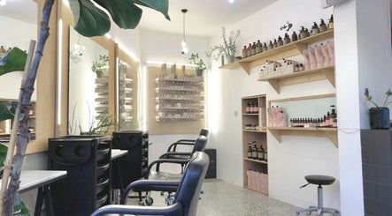 Bright interior of Onics Hair salon, featuring chairs and product displays in London, England, GB.