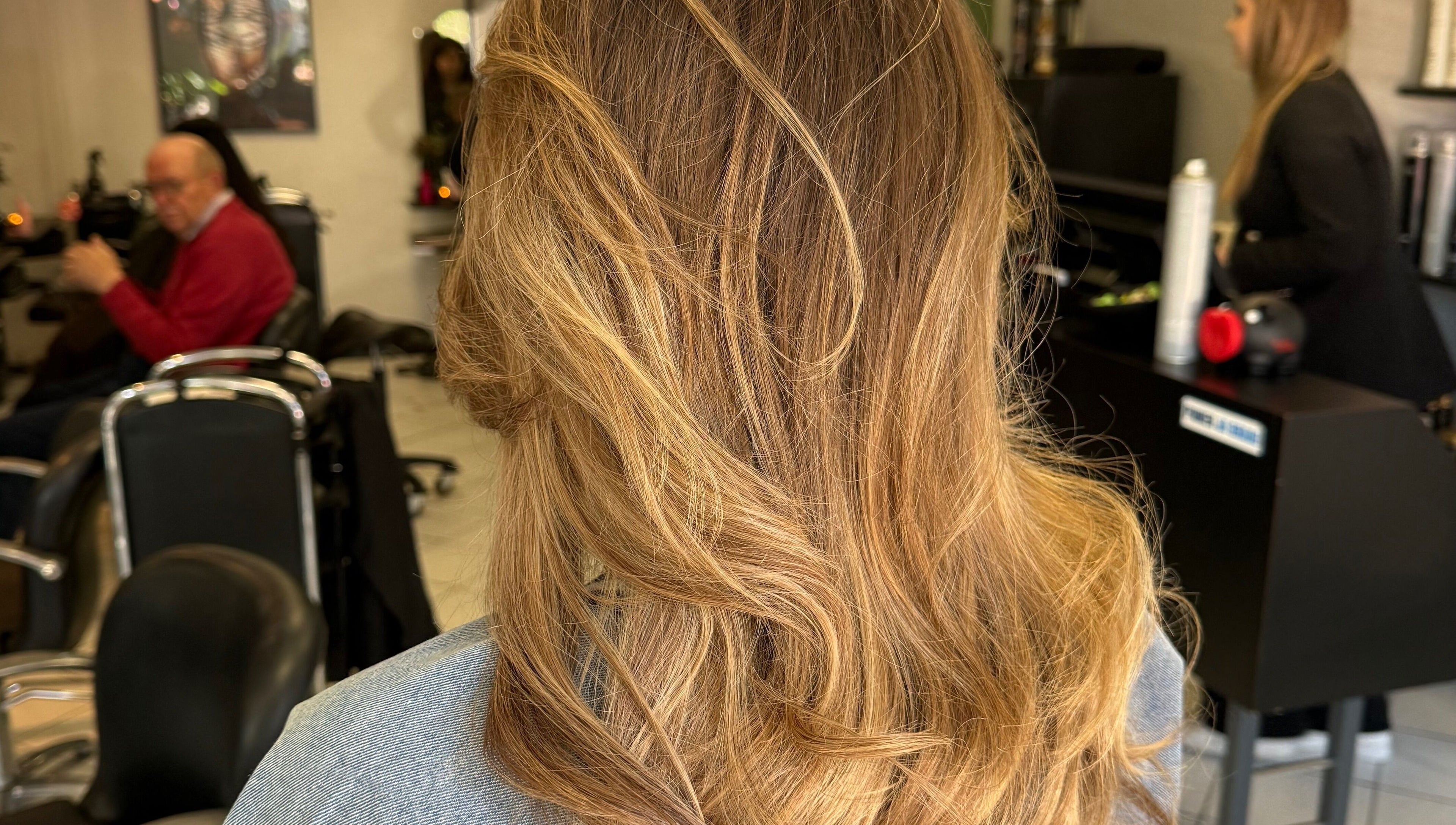 Stylish hair styling at vanDeelen, Randwijk, Gelderland, NL. Blonde waves professionally treated in salon.