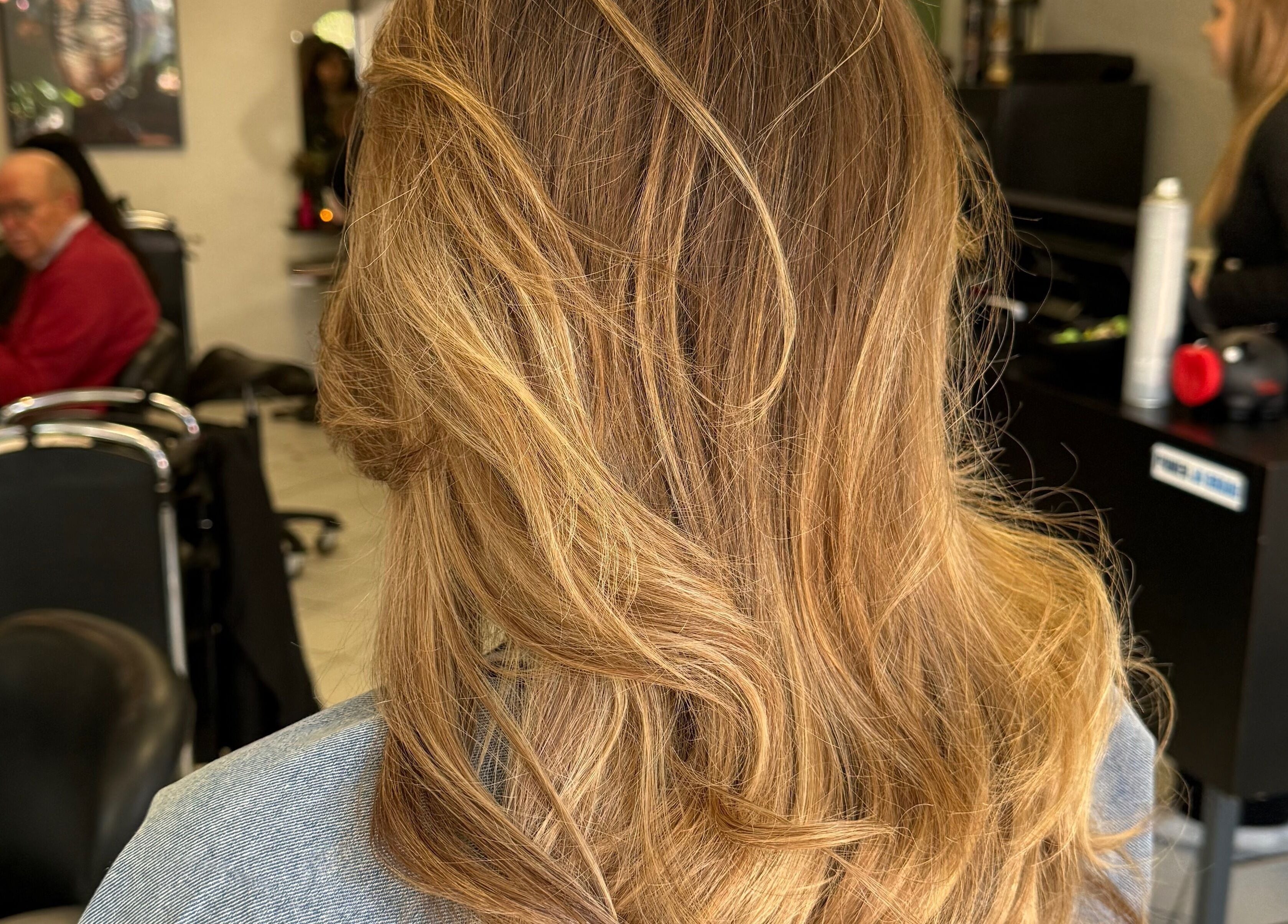 Stylish hair styling at vanDeelen, Randwijk, Gelderland, NL. Blonde waves professionally treated in salon.